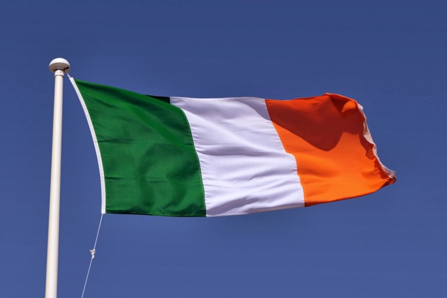The Irish tricolour flag and blue sky.